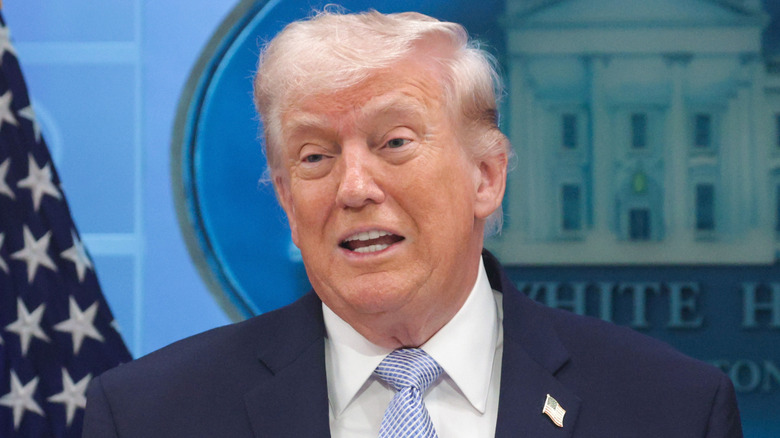 Donald Trump speaking at a podium