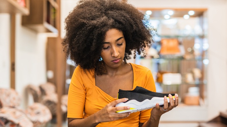 Woman looking at outdated sneakers