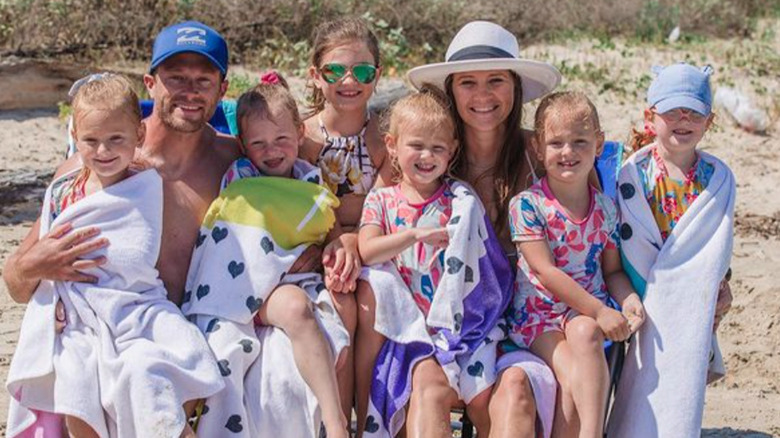 Adam and Danielle Busby take their daughters to the beach.