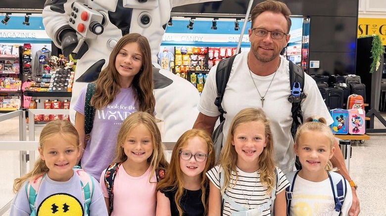 Adam Busby, daughters in airport