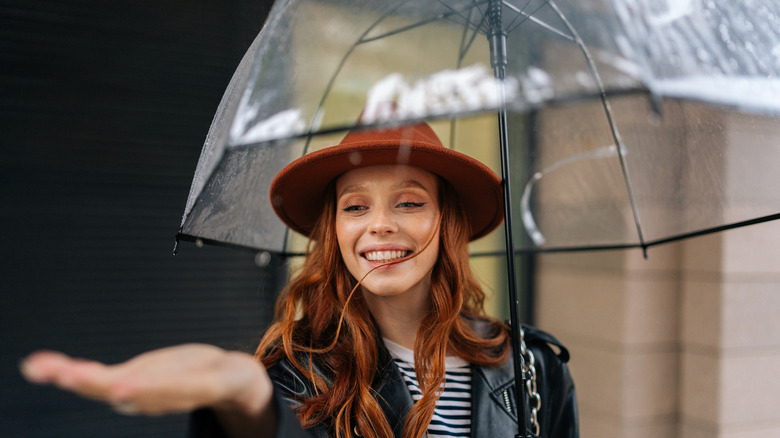 Redhead model with umbrella and hat