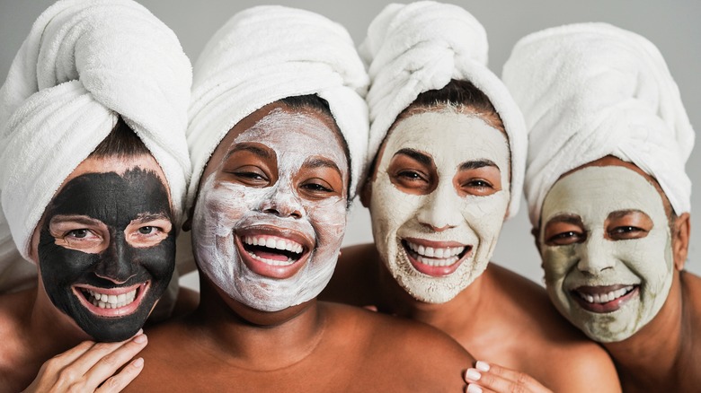 Women wear face masks and towel wraps in their hair