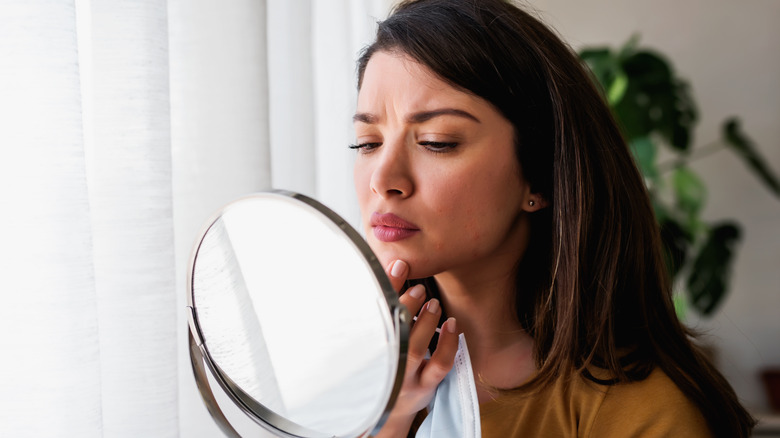 woman pinching facial skin