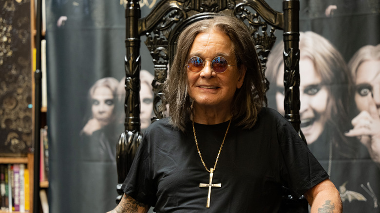 Ozzy Osbourne sits in a chair