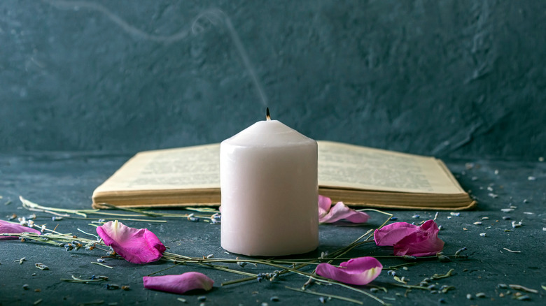 Candle in front of an open book