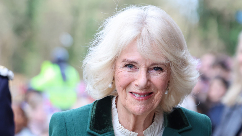 Queen Camilla arrives at she arrives at an event