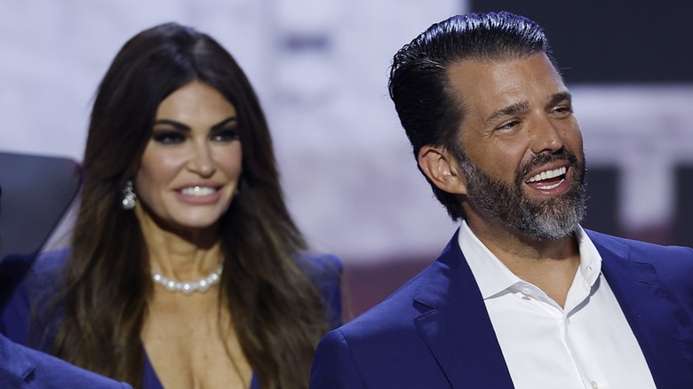 Kimberly Guilfoyle looking at Donald Trump Jr. on stage