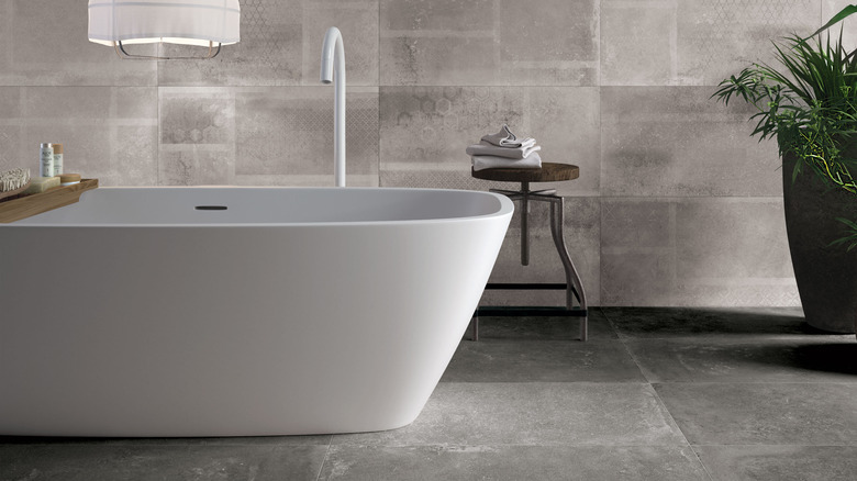 Bathtub situated in grey bathroom