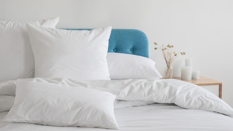 A bed with a blue headboard