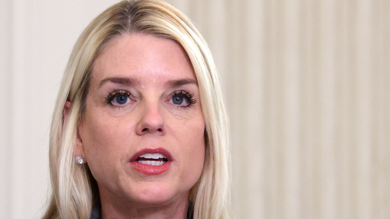Pam Bondi close-up red lipstick diamond earrings