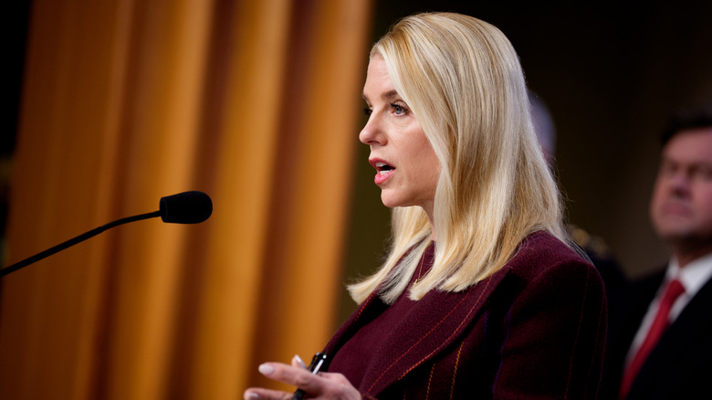 Side profile of Pam Bondi speaking into microphone