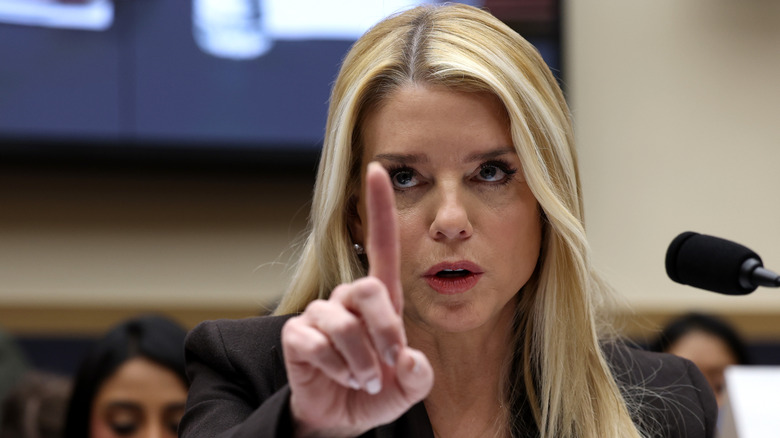 Closeup of Pam Bondi wagging her finger as she speaking into microphone