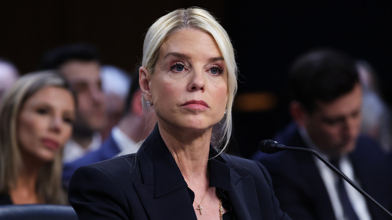 Pam Bondi wearing a serious expression while being questioned at a hearing