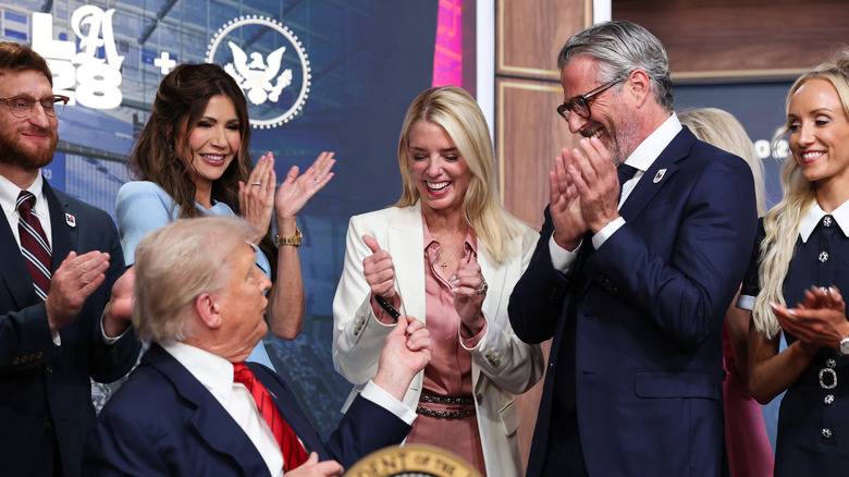 Pam Bondi claps after Donald Trump signed an executive order