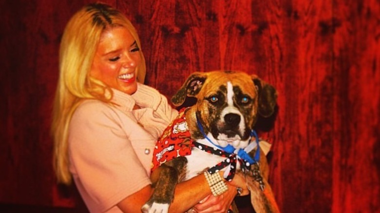 Pam Bondi holds a confused dog in Florida (2013)