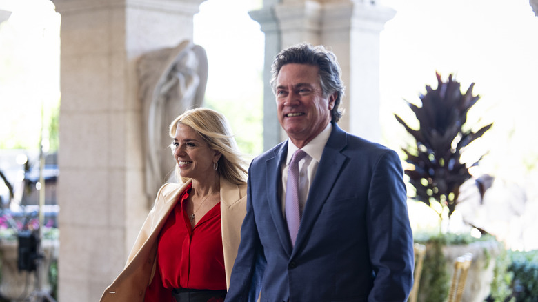 Pam Bondi and John Wakefield walking and smiling