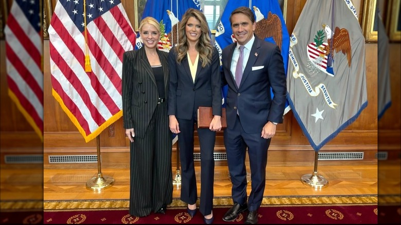 Pam Bondi, Lindsey Halligan, and a man smiling together