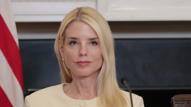 Attorney General Pam Bondi wearing a white shirt while speaking at a round table.