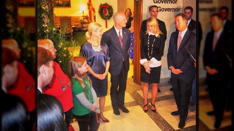 Pam Bondi and others standing by Christmas tree