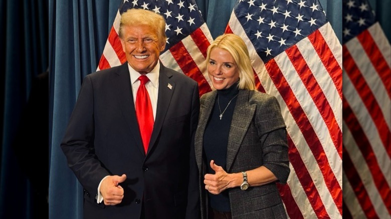 Donald Trump and Pam Bondi pose next to each other giving the thumbs up (2024)