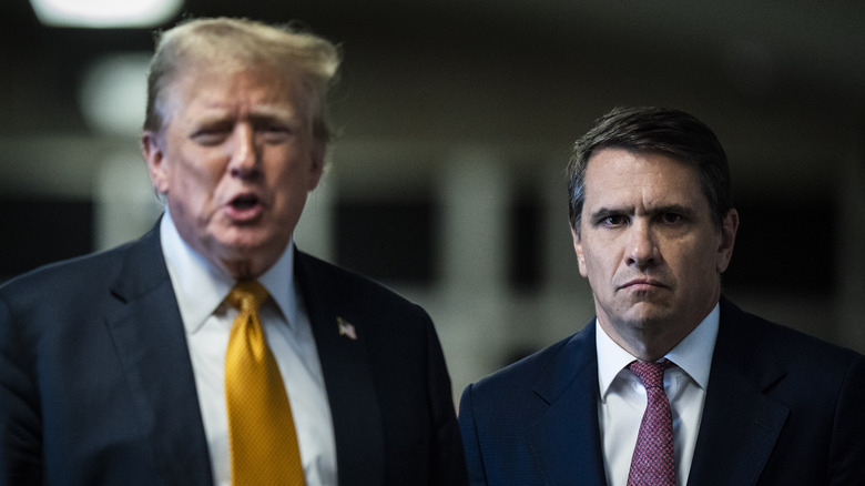 Donald Trump standing next to Todd Blanche