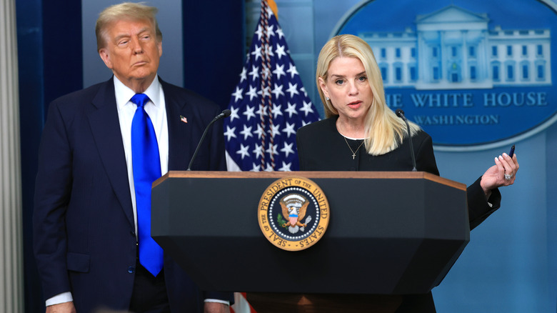 Pam Bondi speaking to the press with Donald Trump beside her