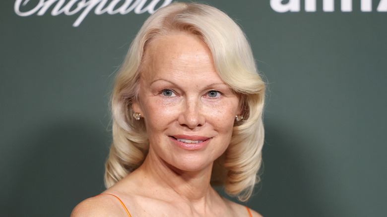Pamela Anderson smiling. and posing at event.