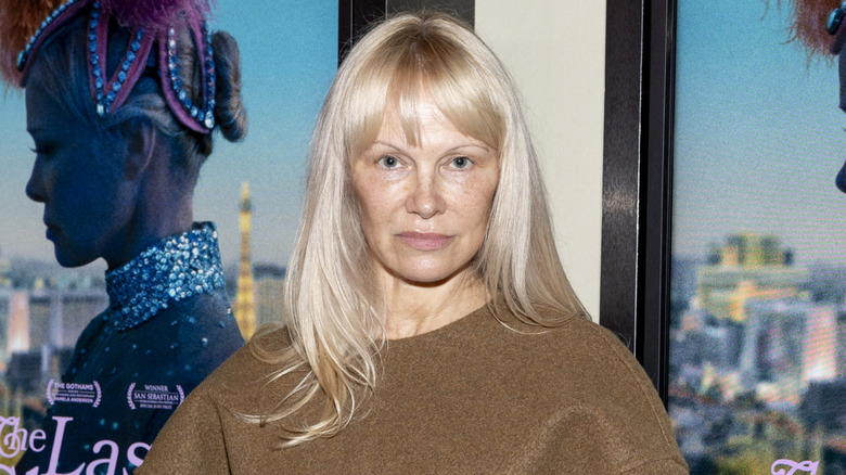 Pamela Anderson with long blond hair and bangs at a Last Showgirl premiere