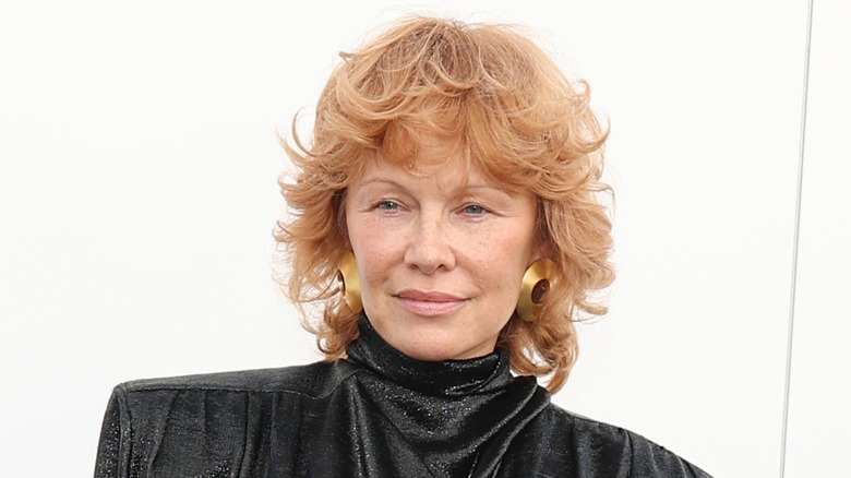 Pamela Anderson at Fashion Week in 2025 with red hair