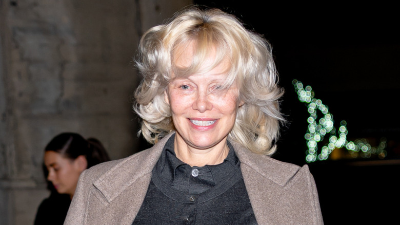 Pamela Anderson smiling and walking down the street in February 2026