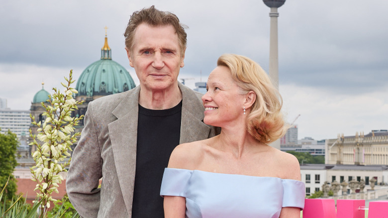 Pamela Anderson smiling at Liam Neeson