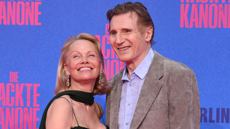 Pamela Anderson and Liam Neeson smiling