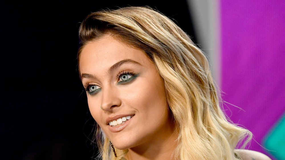 Paris Jackson smiles for photographers