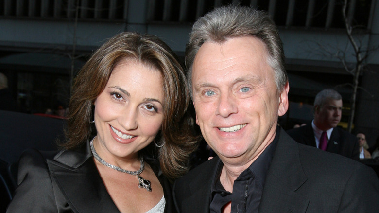 Pat Sajak and Lesly Brown posing and smiling.