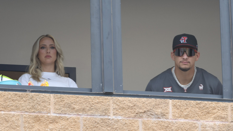 Brittany and Patrick Mahomes watch game three of the Division I Women's Softball Championship series