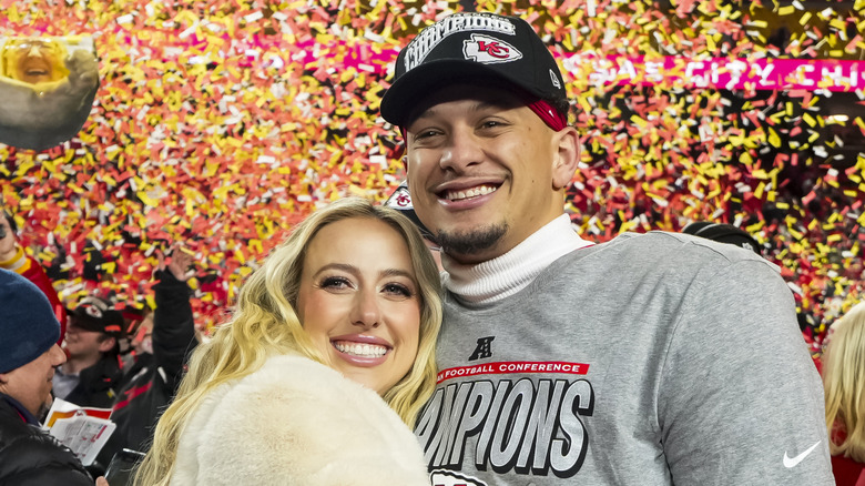 Brittany and Patrick Mahomes on the field after a Chiefs win