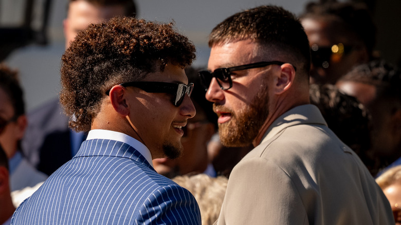 Patrick Mahomes and Travis Kelce in suits and sunglasses