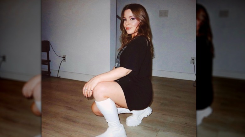 Lulu Simon crouching and smiling