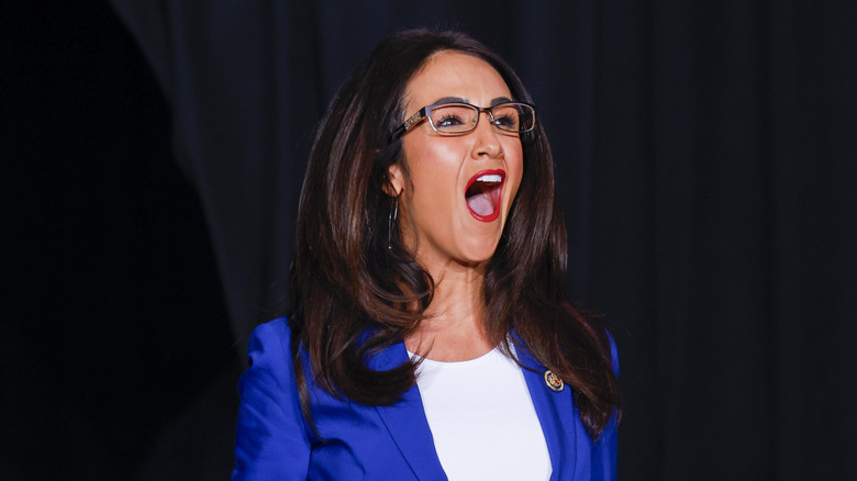 Lauren Boebert stands with her mouth open, mid-speech