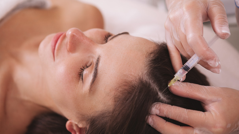 Woman getting injection in scalp