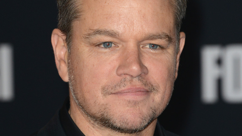 Matt Damon grinning with facial scruff