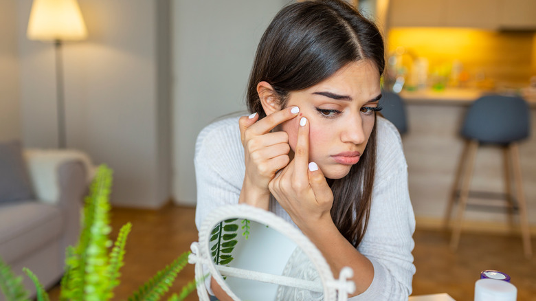 Woman popping her pimple