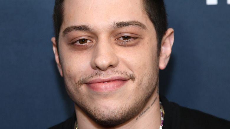 Pete Davidson smiles on the red carpet