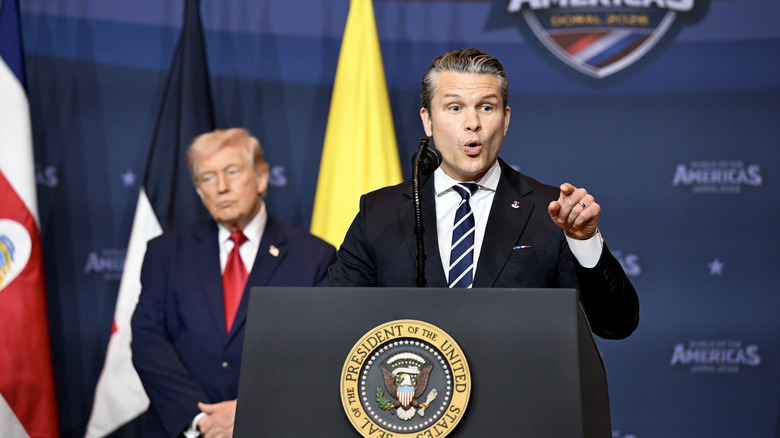 Pete Hegseth talks while Donald Trump looks bored in the background.