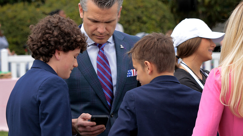 U.S. Secretary of Defense Pete Hegseth looks at his mobile phone during the White House Easter Egg Roll on the South Lawn of the White House on April 21, 2025 in Washington, DC.