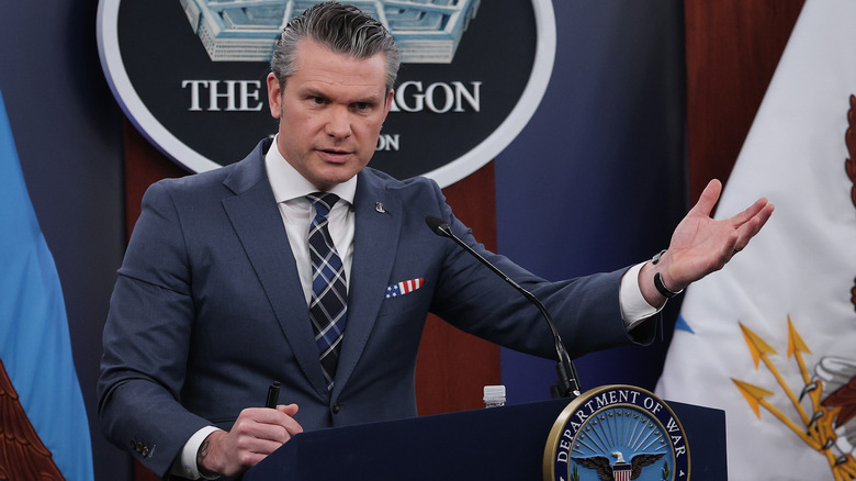 U.S. Secretary of War Pete Hegseth (C) talks about the war in Iran as President Donald Trump hosts the swearing-in ceremony for U.S. Secretary of the Department of Homeland Security Markwayne Mullin (R) in the Oval Office at the White House on March 24, 2026 in Washington, DC.