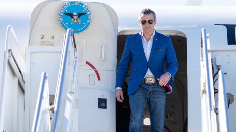 Pete Hegseth smiling and wearing sunglasses