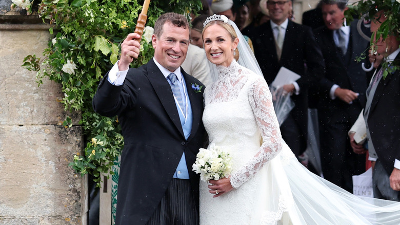 Peter Phillips posing with his wife Harriet Spurling, who wears a lace wedding gown and a small tiara