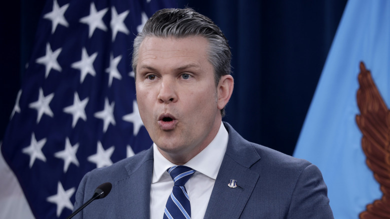 Pete Hegseth speaking at podium