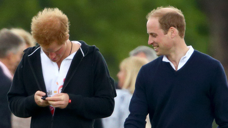 Harry, William look at phone
